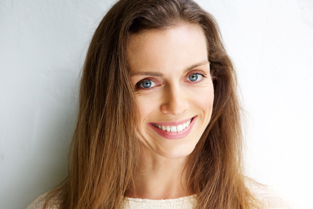 Close,Up,Portrait,Of,A,Beautiful,Middle,Aged,Woman,Smiling