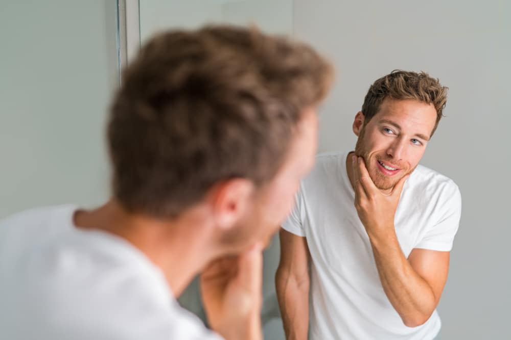 Male,Beauty,Young,Man,Touching,Beard,And,Face,Looking,In