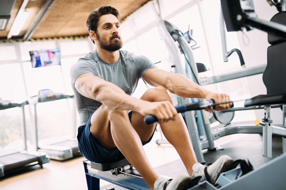 Young,Handsome,Man,Doing,Exercises,In,Gym